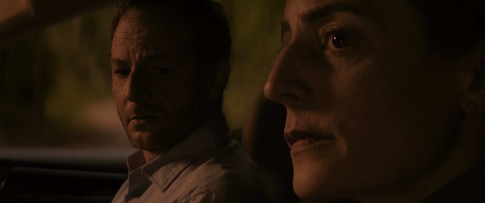Still from CHILD: a man and a woman in a car at dusk