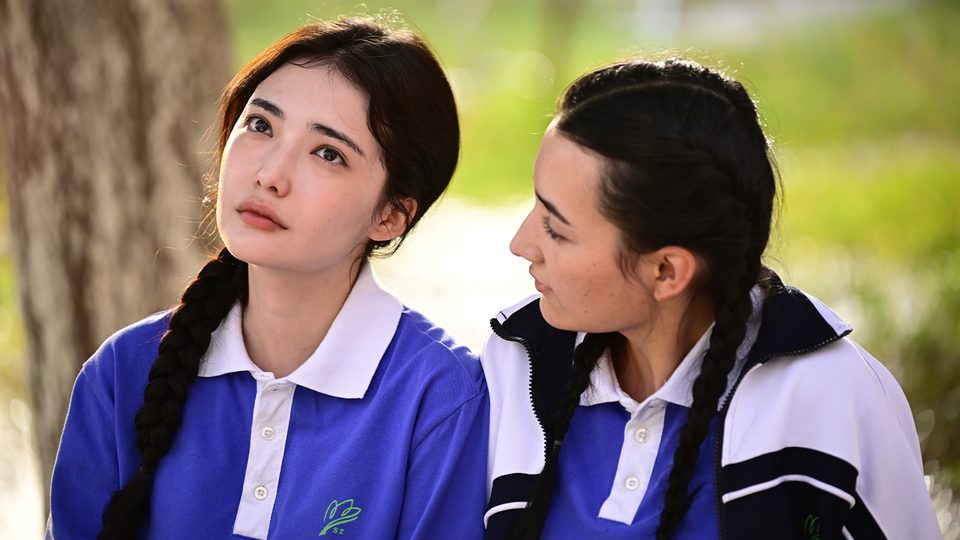 Still from A Palmful of Stars: two young women in school uniforms
